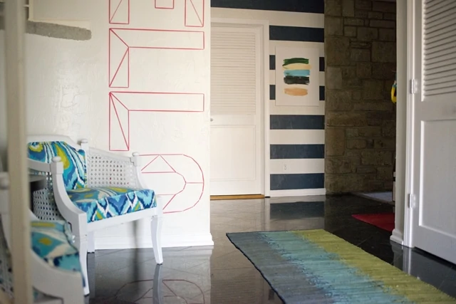 Bold and Bright Entryway with painted stripes on a textured wall