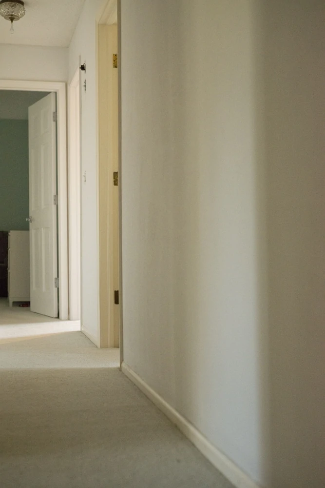 Dated hallway with wallpaper removed