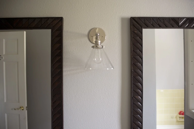 sconce between mirrors