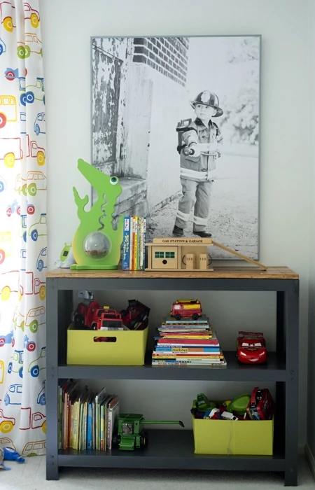 Poster print of fireman in kids room with kids bookshelf underneath