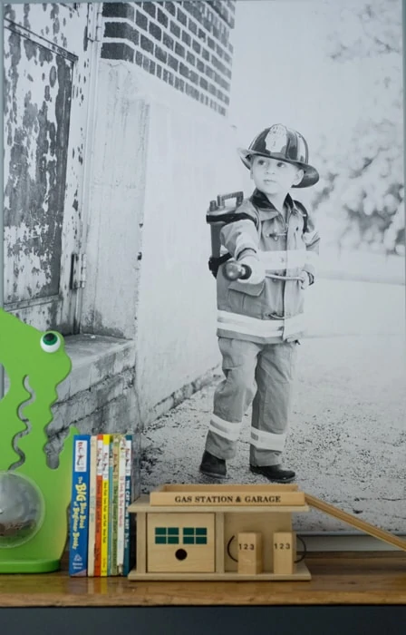 Kid dressed up in fireman costume poster print