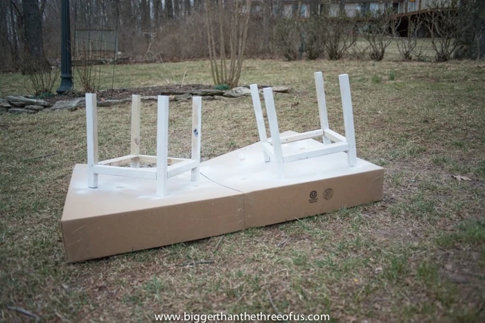 Spray painting the DIY Outdoor Planters bases to make them white