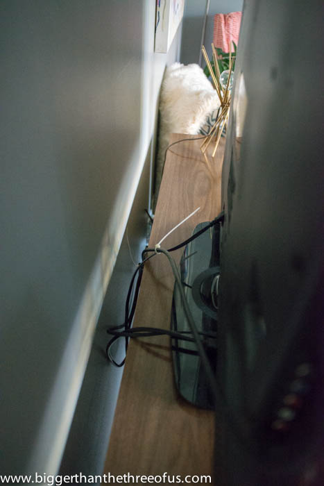 Hiding TV wires showing Zip-tie cords together to manage the amount of cords that you have