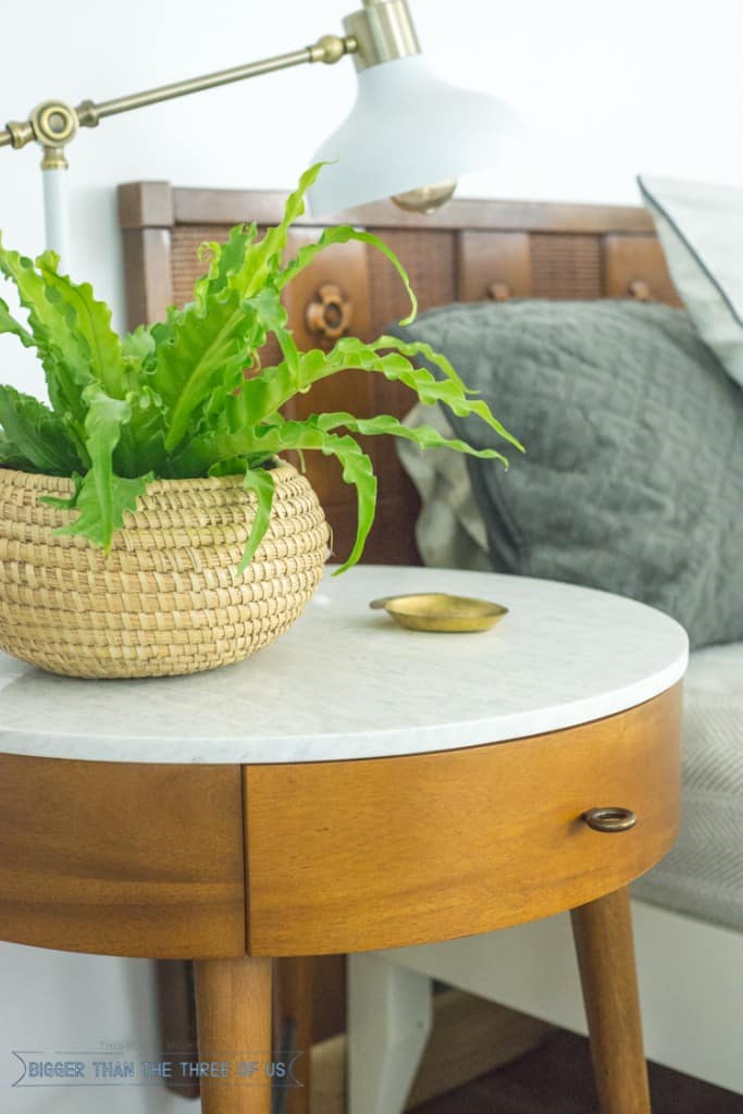 Modern Eclectic Mid-Century Bedroom with white duvet , West Elm nightstand, blue and white rug and plants