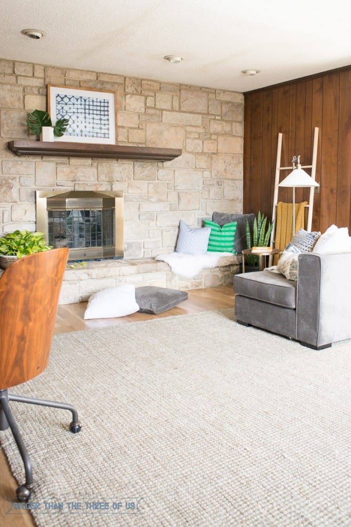 Stacked stone fireplace in playroom