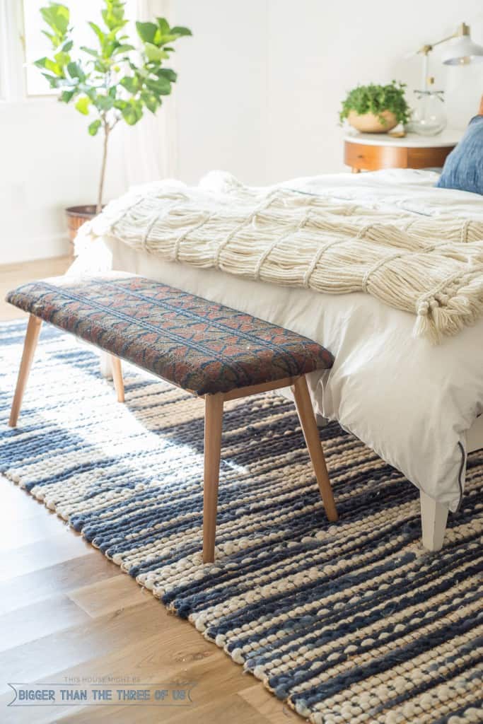 Add texture to your room by upholstering a plain bench with a vintage distressed rug.