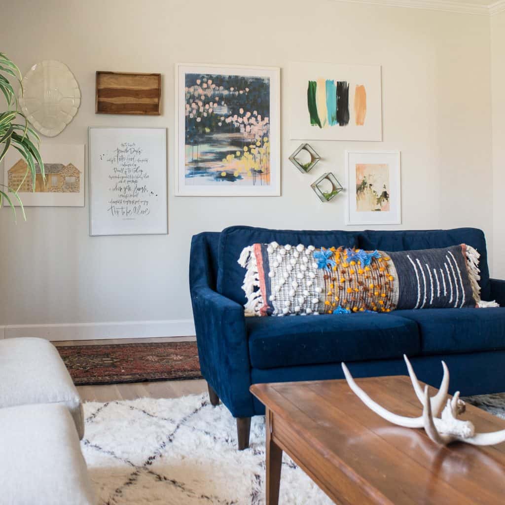 Living Room with Navy couch, moroccan rug and gallery wall 