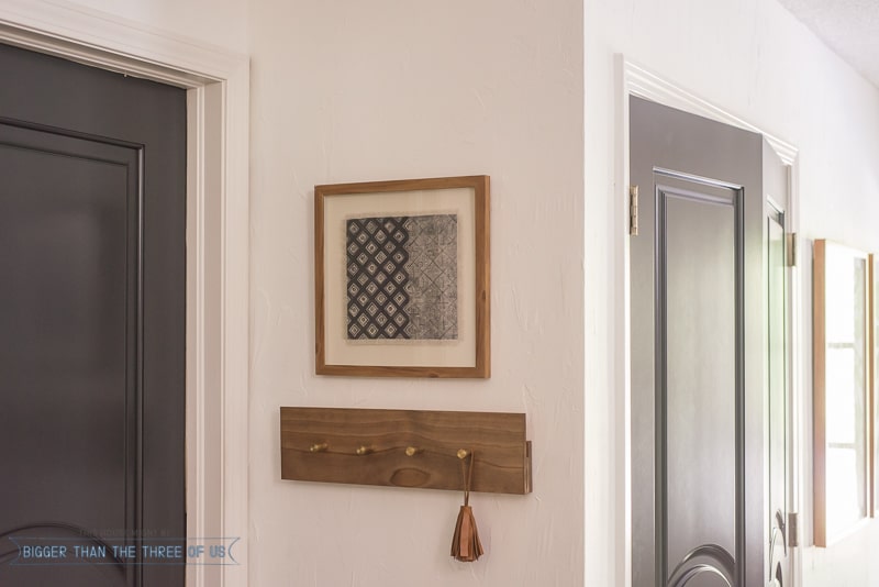 Black interior door with DIY coat rack and leather tassel 