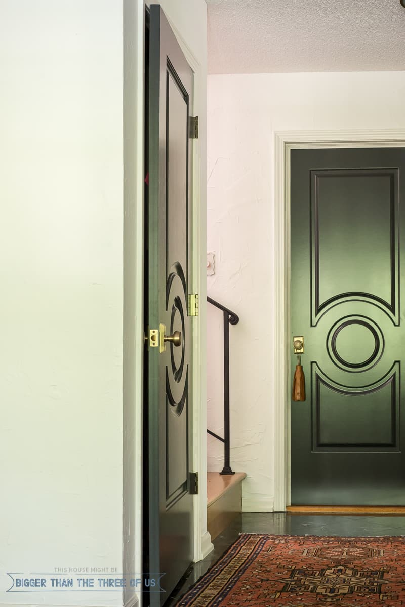 Dark interior doors with marble flooring and a vintage rug 