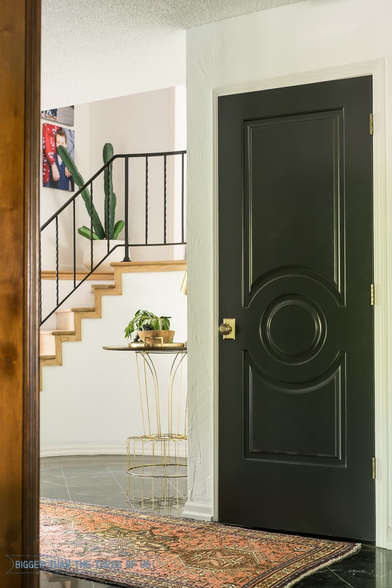 Round Entryway with dark doors and dark flooring 