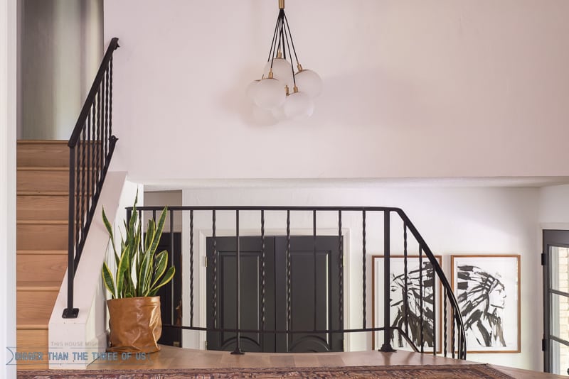 Modern Entryway with dark railing and dark doors