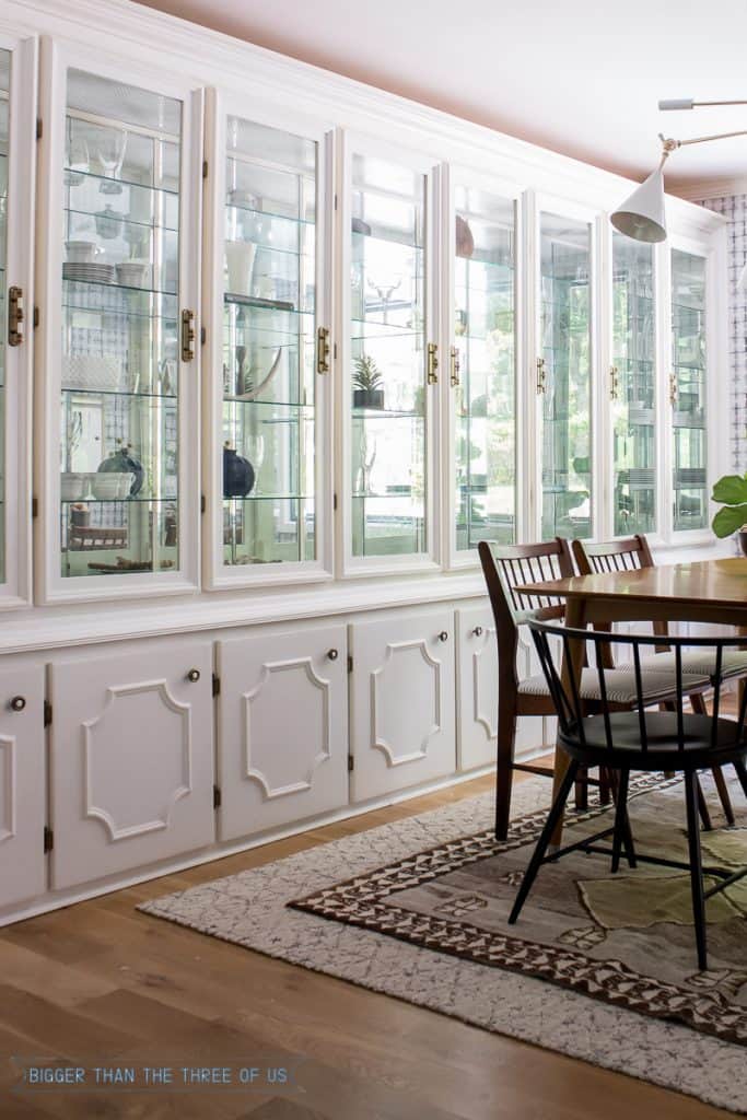 Built-In Cabinet in Dining Room with layered rugs, vintage furniture and more. 