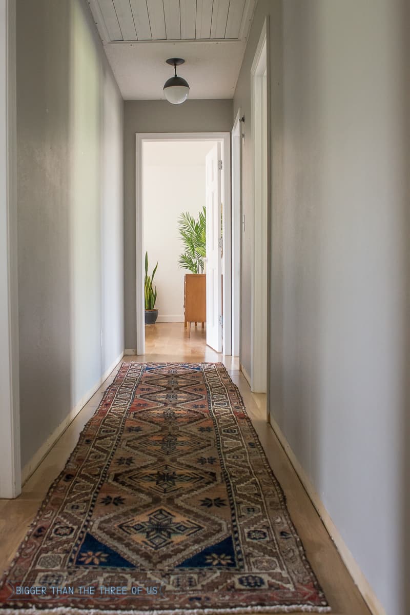 Persian rug in hallway with gallery wall 