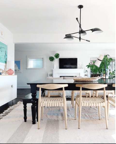 Tv above mantle on a white wall. How to minimize the look of the tv with home decor items.