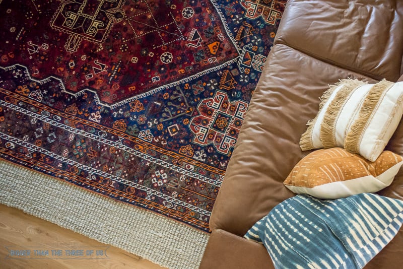 Vintage rug layered over jute rug in living room. How to Search for Cheap Vintage Rugs