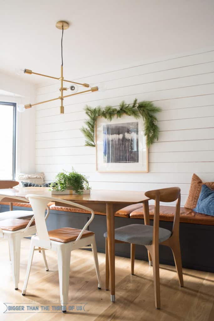 Garland over art hanging in dining room. Modern shiplap walls in Christmas Home Tour. 