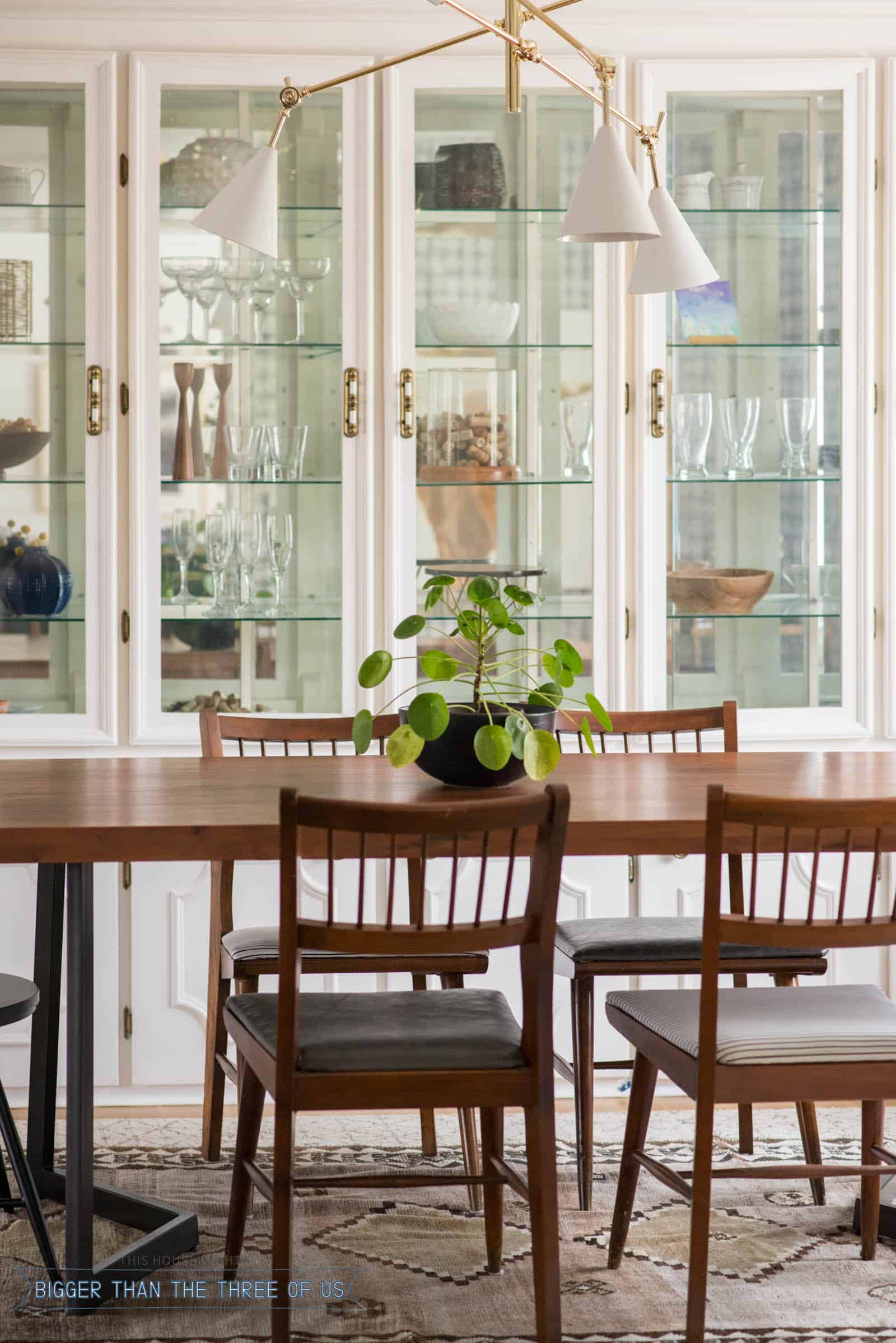 Leather upholstered midcentury chairs with black spindle chairs in dining room