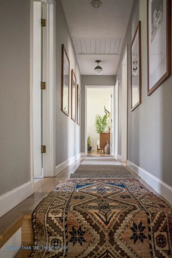 Vintage runner in hallway with gallery wall