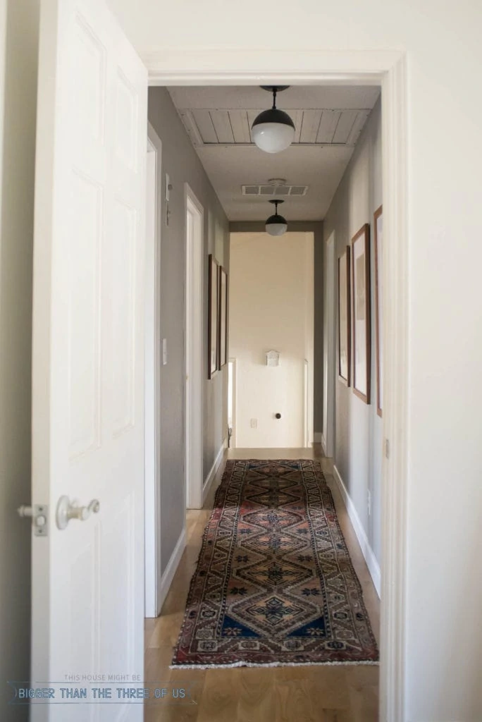 Travel Gallery Hallway with black and white photos and vintage runner.