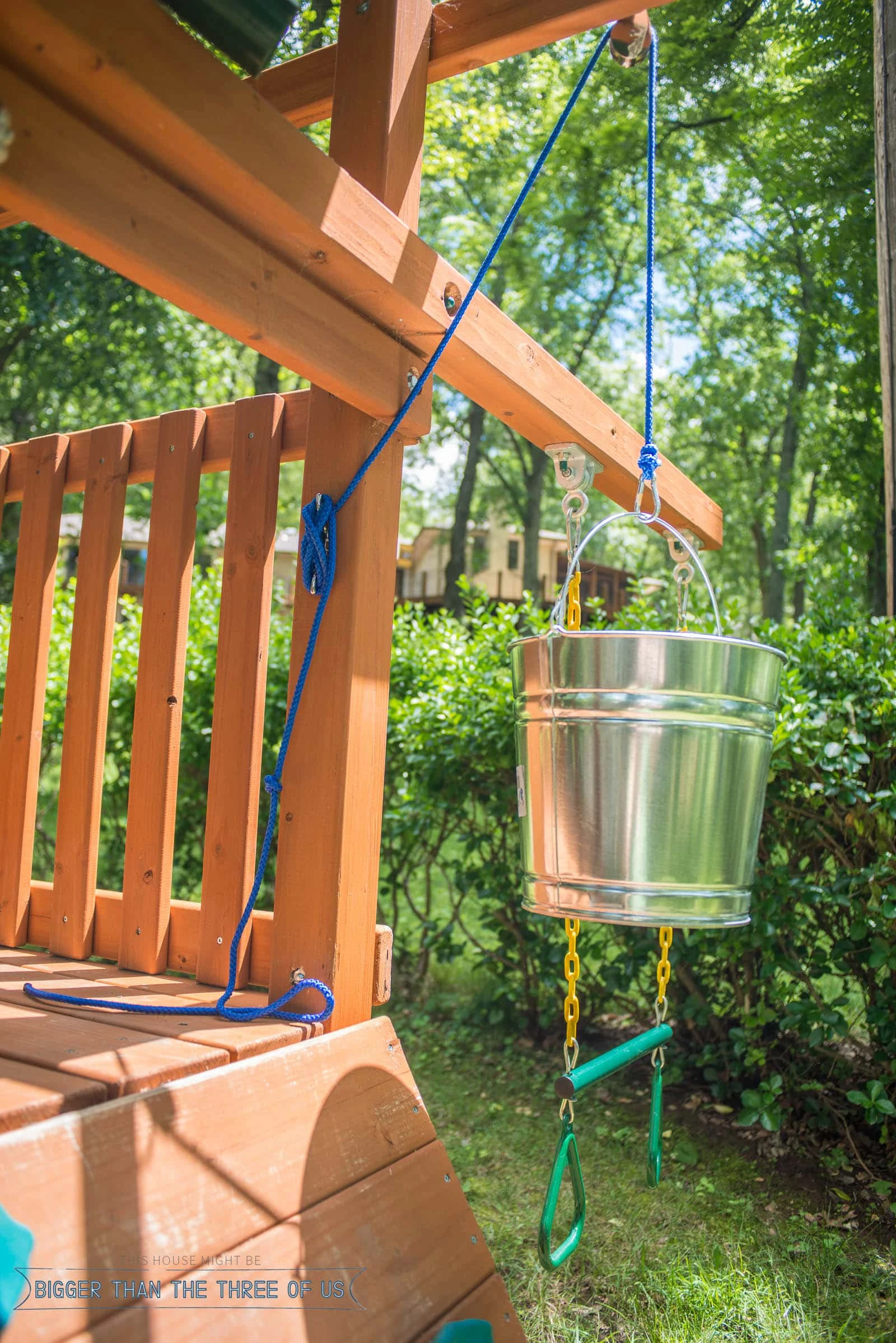 Add a bucket and pulley to a playset.