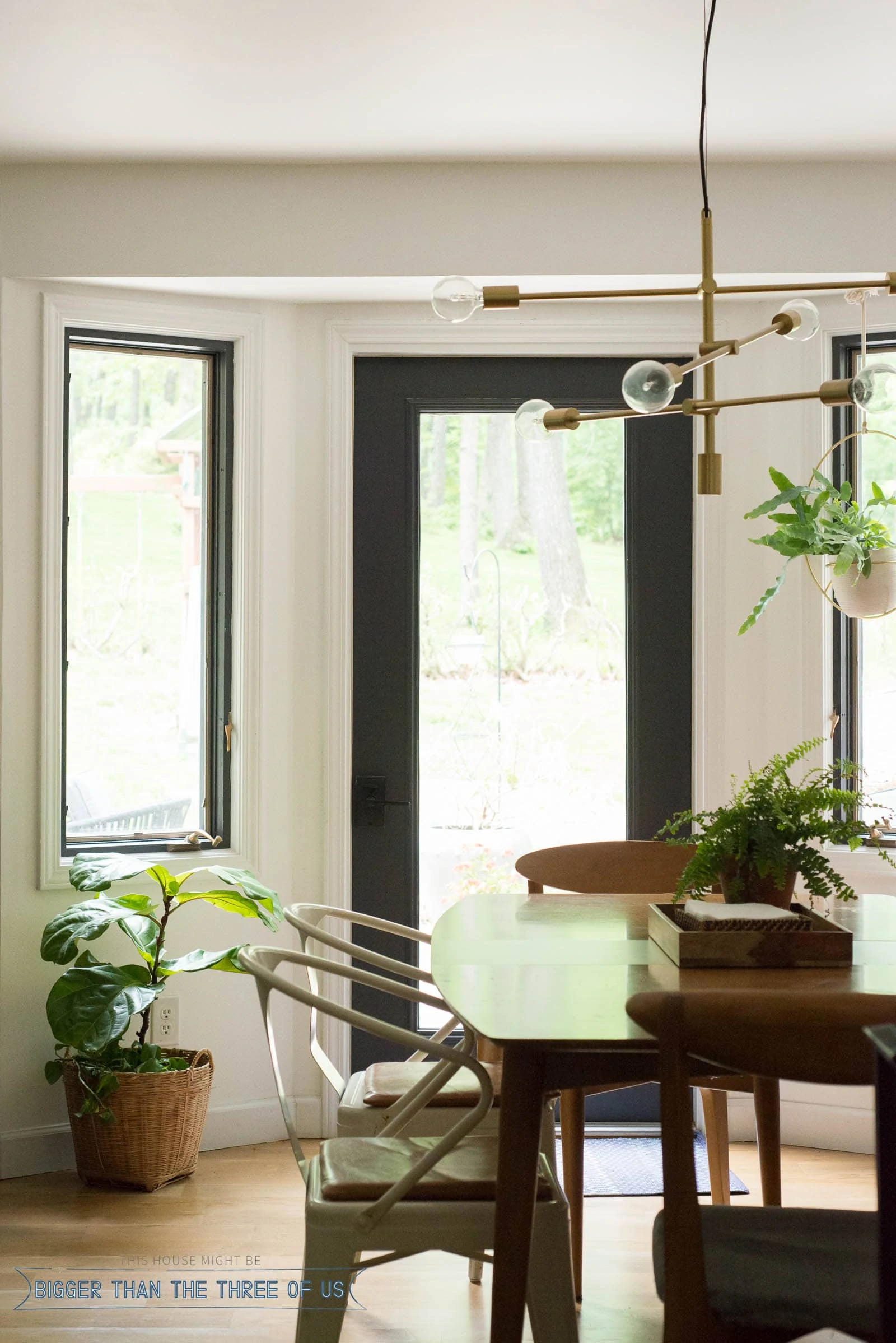 Dining room with bench seat, brass chandelier and leather seat cushions