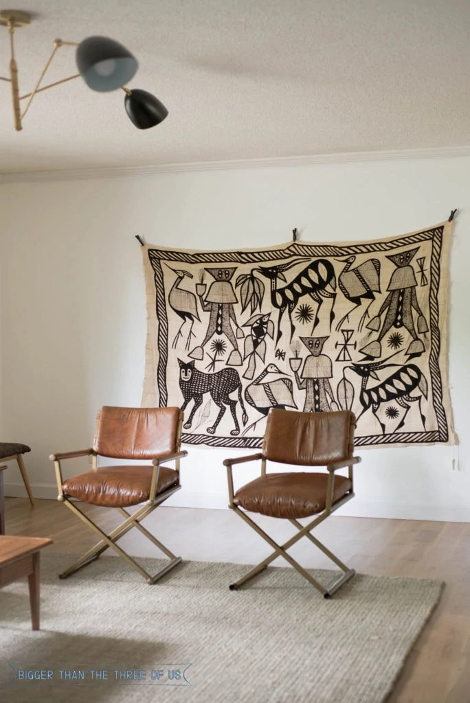 Oversized vintage textile on wall in living room.