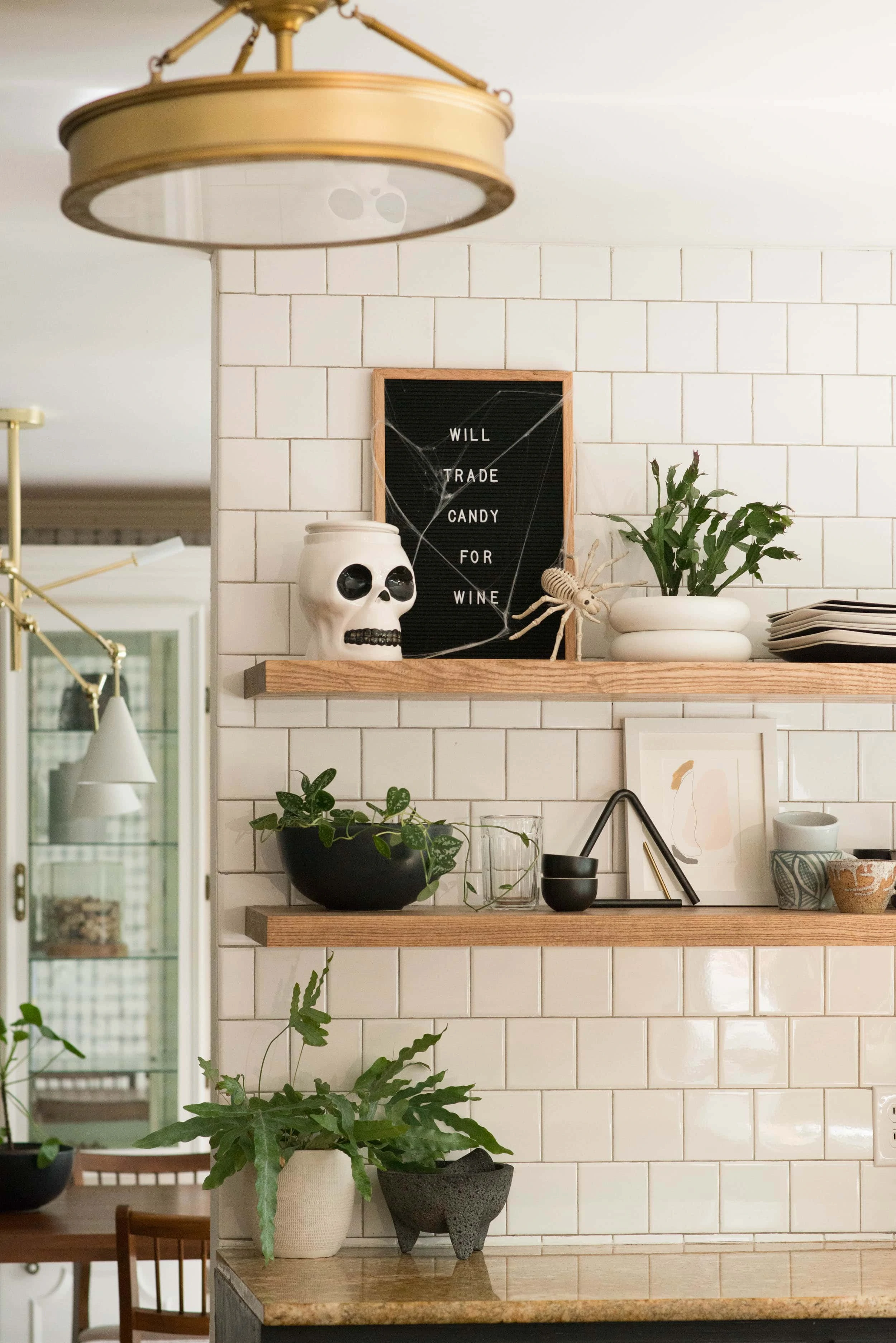 I love putting a sprinkle of halloween decor on my floating kitchen shelves. Come on over and see more Halloween decor ideas for your home. #halloweendecor #floatingshelves