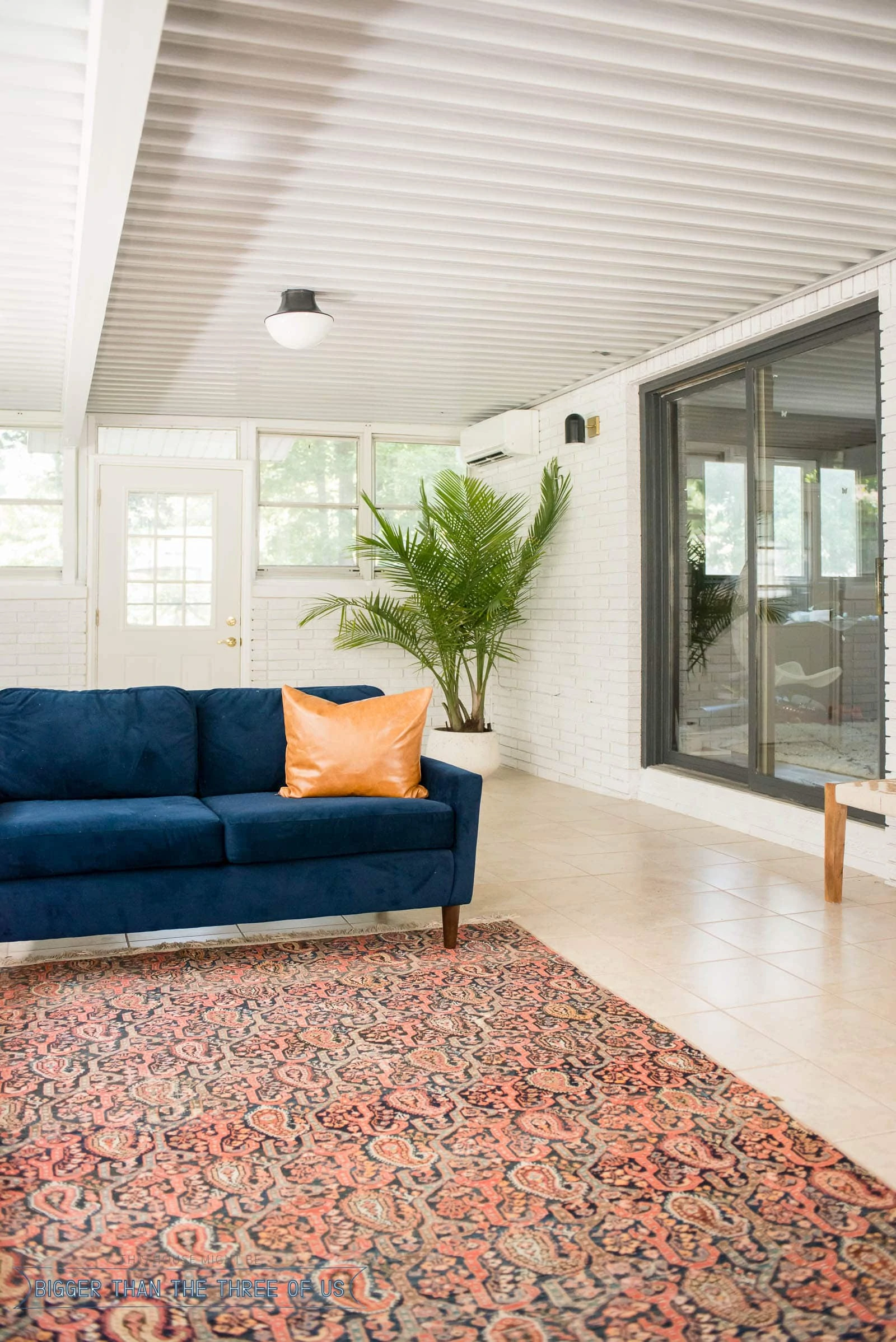 Sunroom Office with windows on three sides and brick walls.