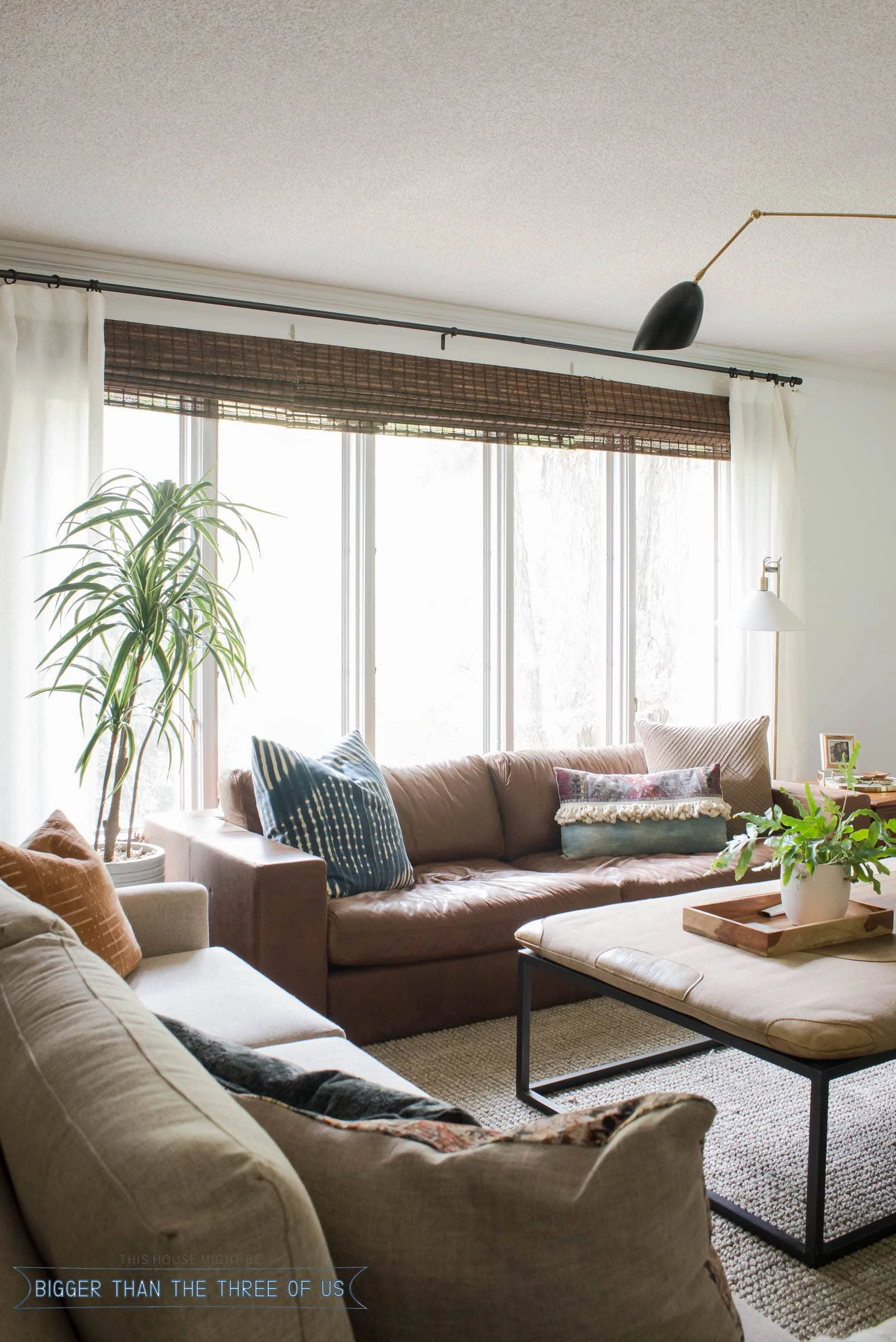 Leather Couch in front of windows in midcentury inspired living room