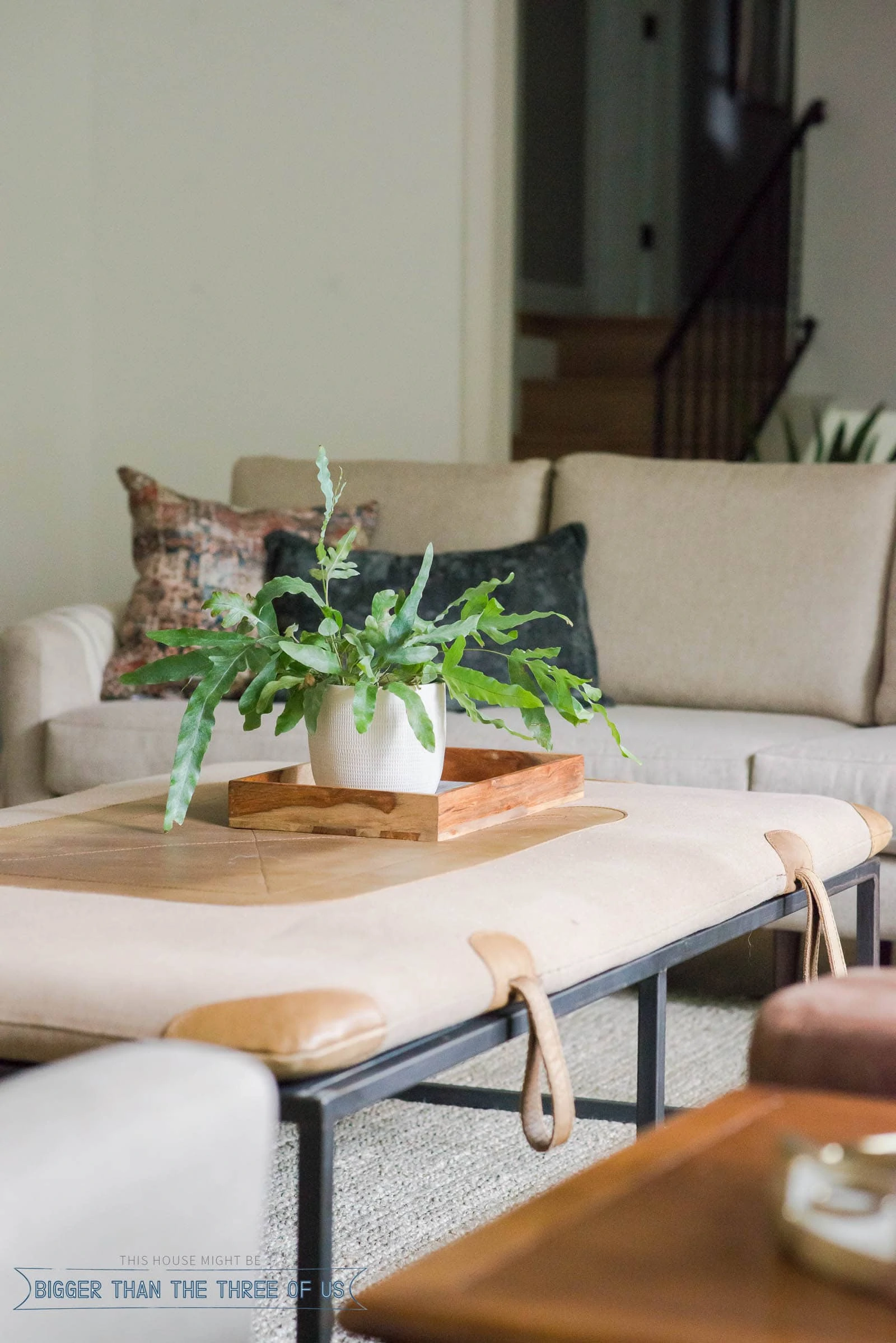 A vintage upholstered equestrian pad for a steel oversized coffee table