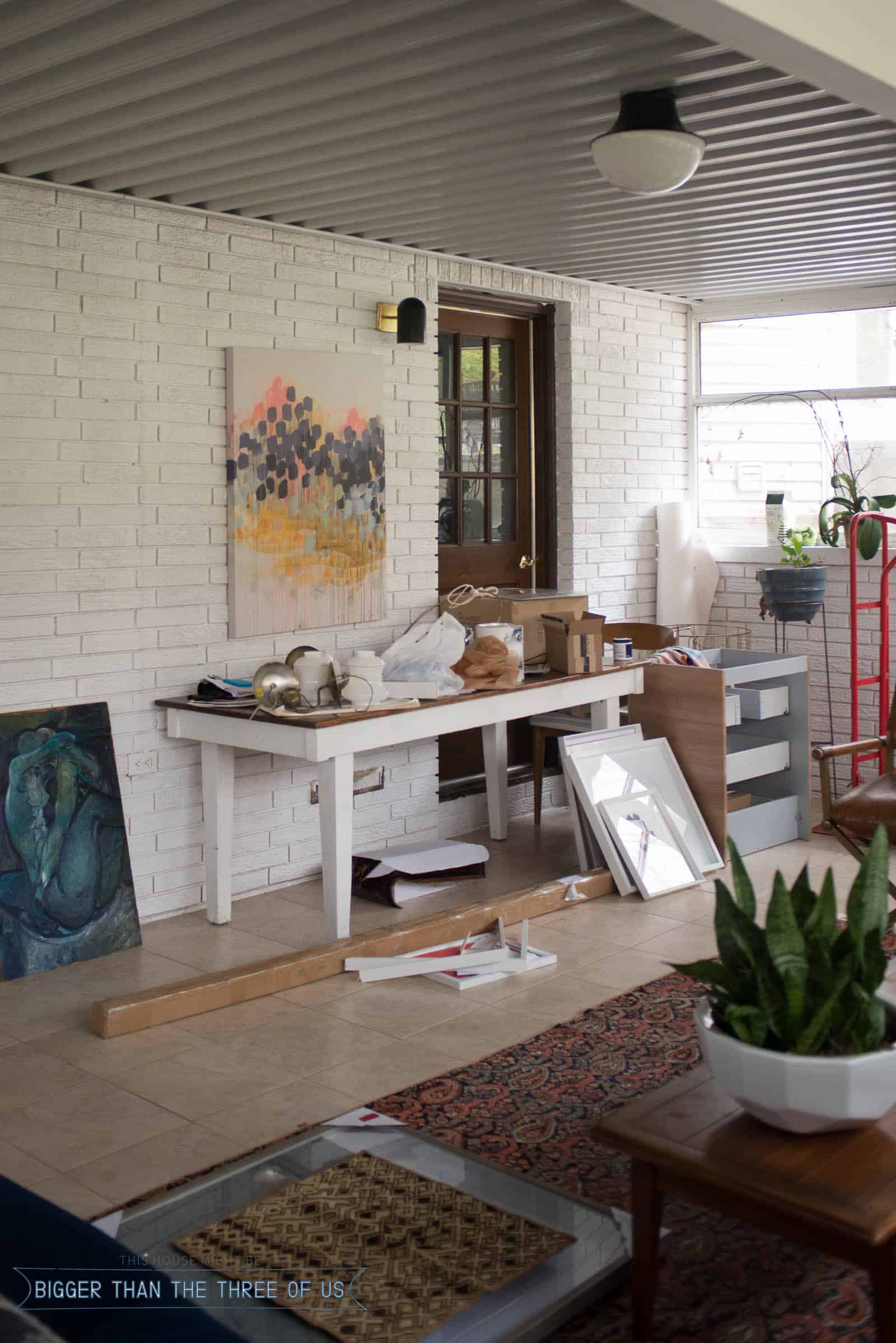 Wall in sunroom with projects supplies on table