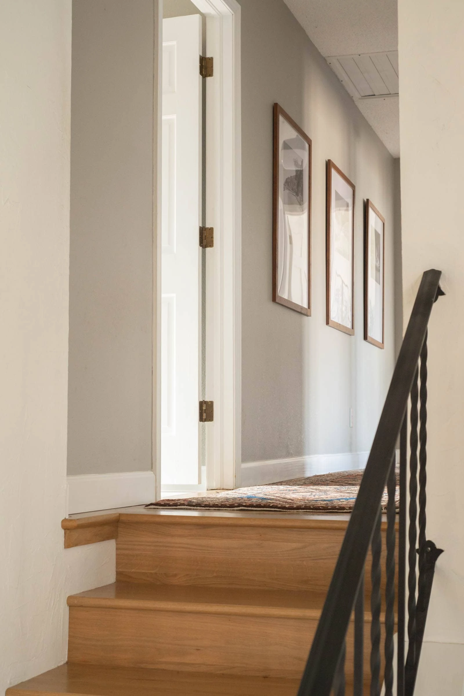 Wood stairs and a gray hallway