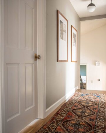 White door and brass hardware in upstairs hallway