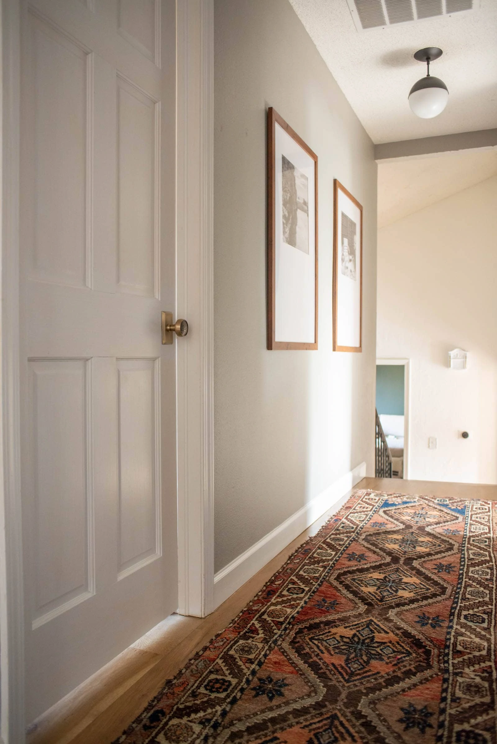 White door and brass hardware in upstairs hallway