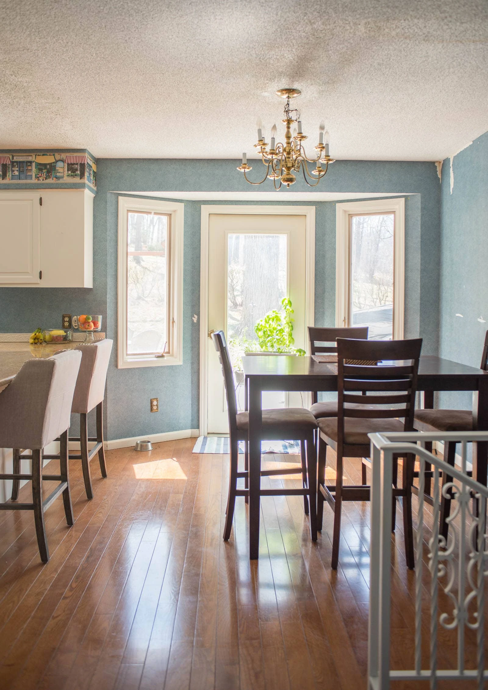 Blue wallpaper in kitchen with wood floors