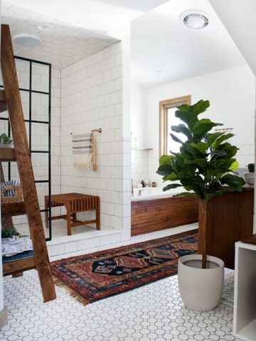 View of shower and bathtub and white tile floor.