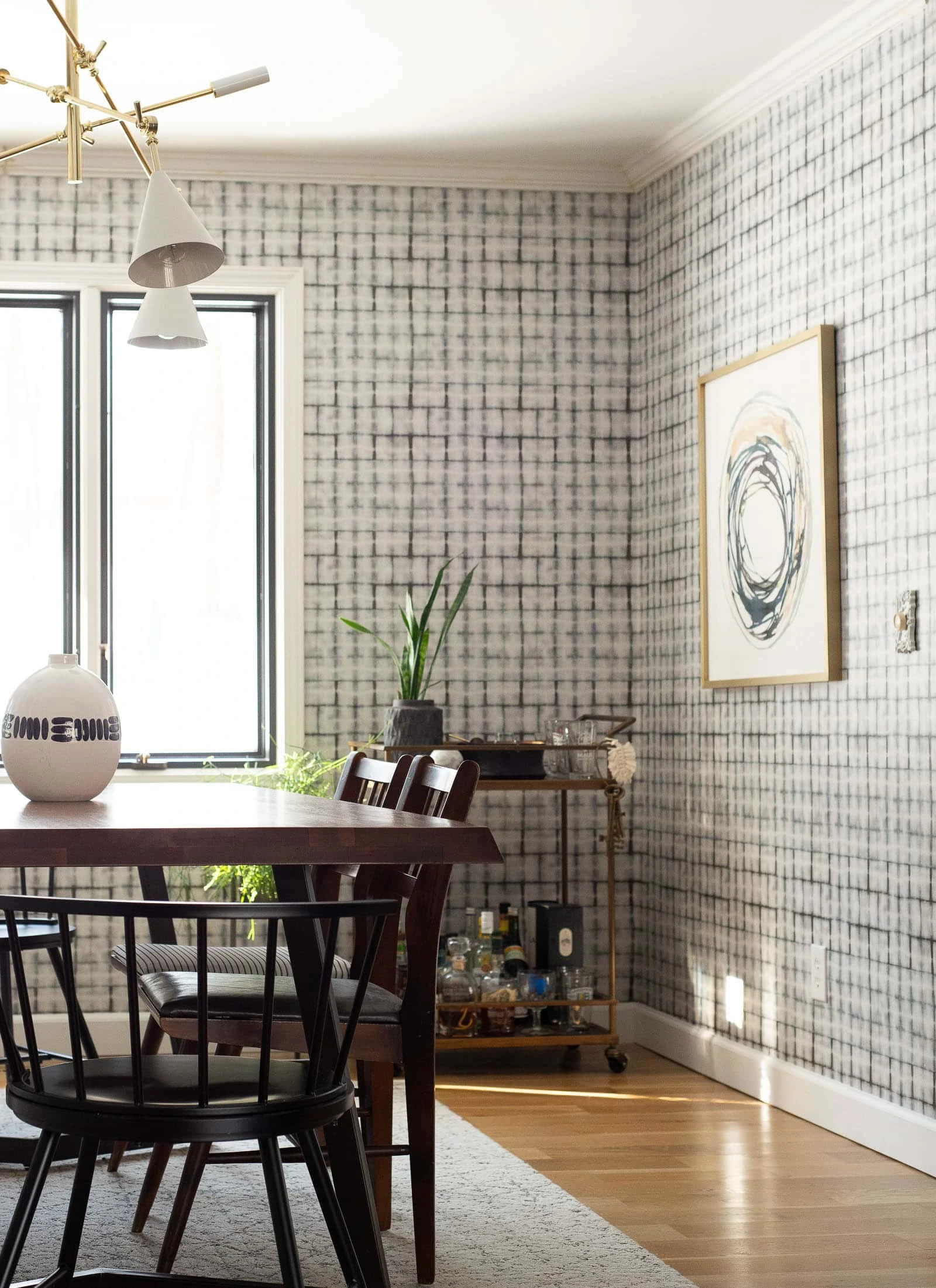 Dining room with wallpaper and art on the wall