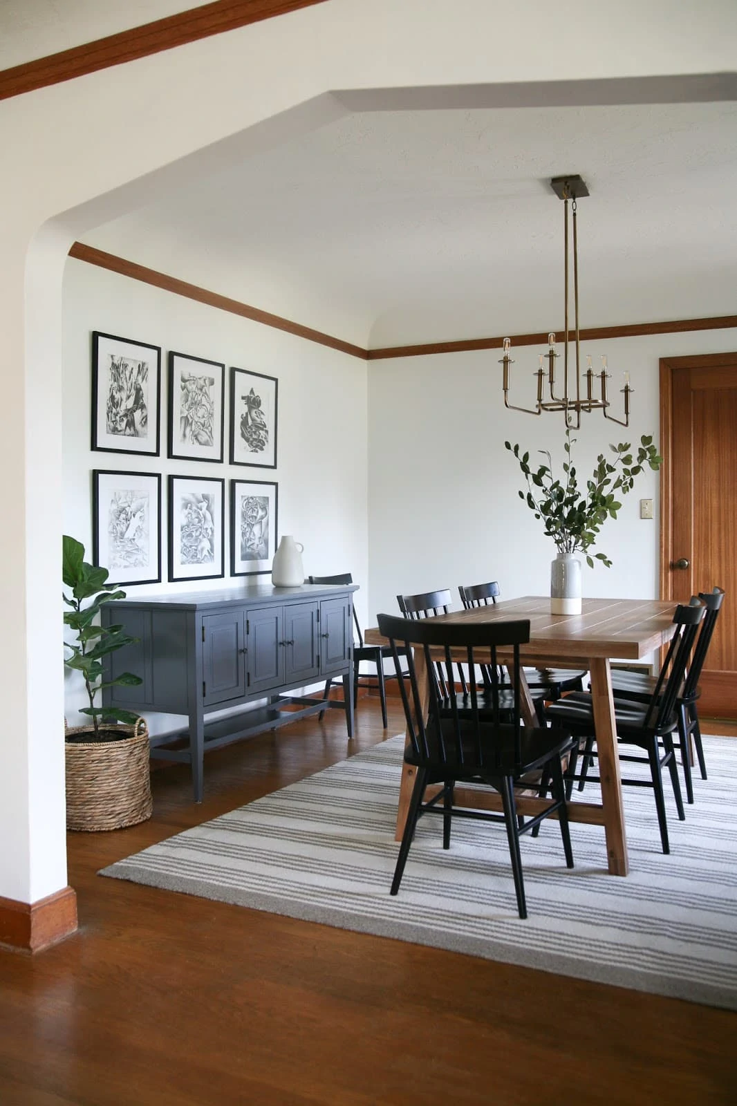 Dining room featuring a striped rug, black and white art and more,