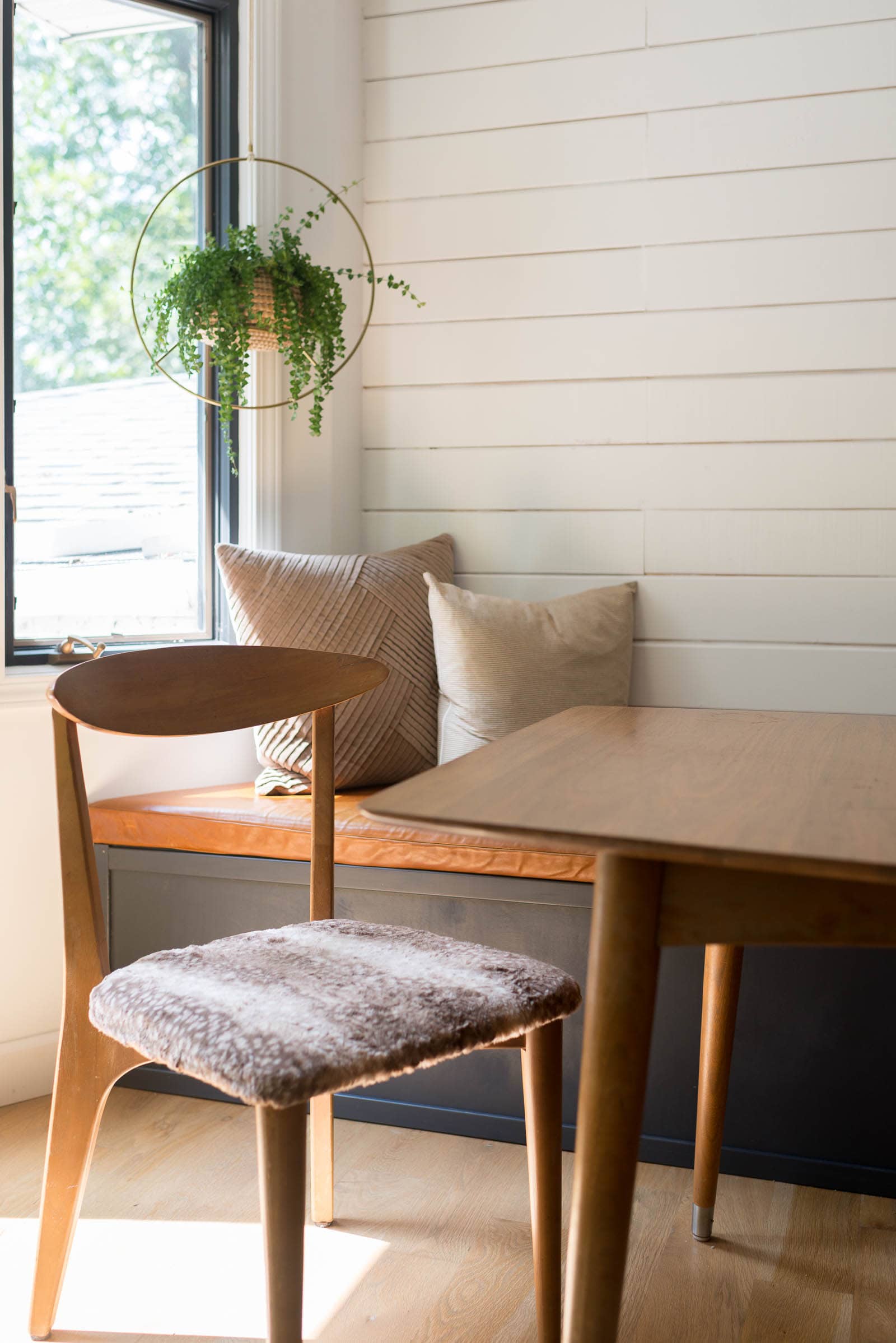 Midcentury chair by banquette in dining room