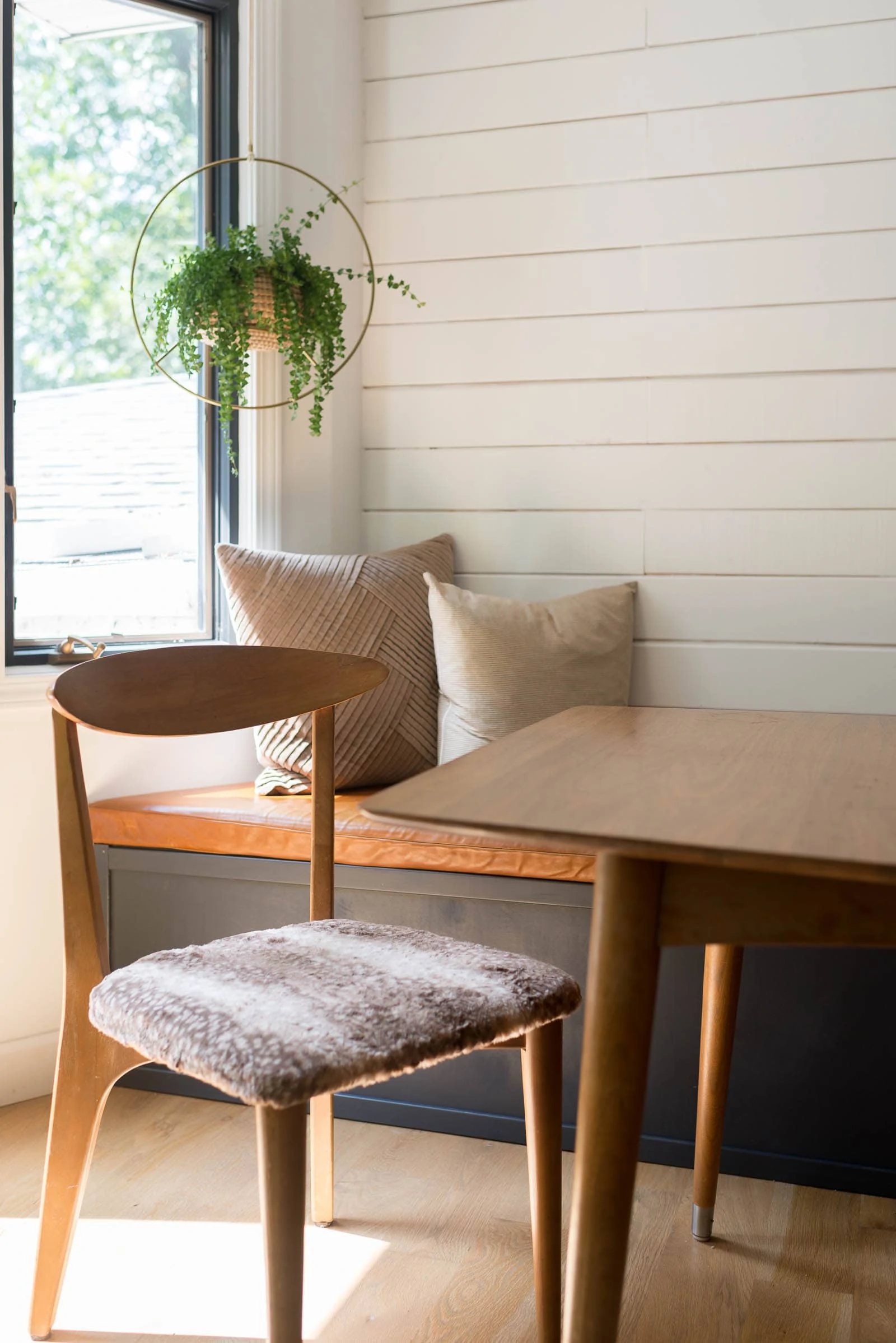 Midcentury chair by banquette in dining room