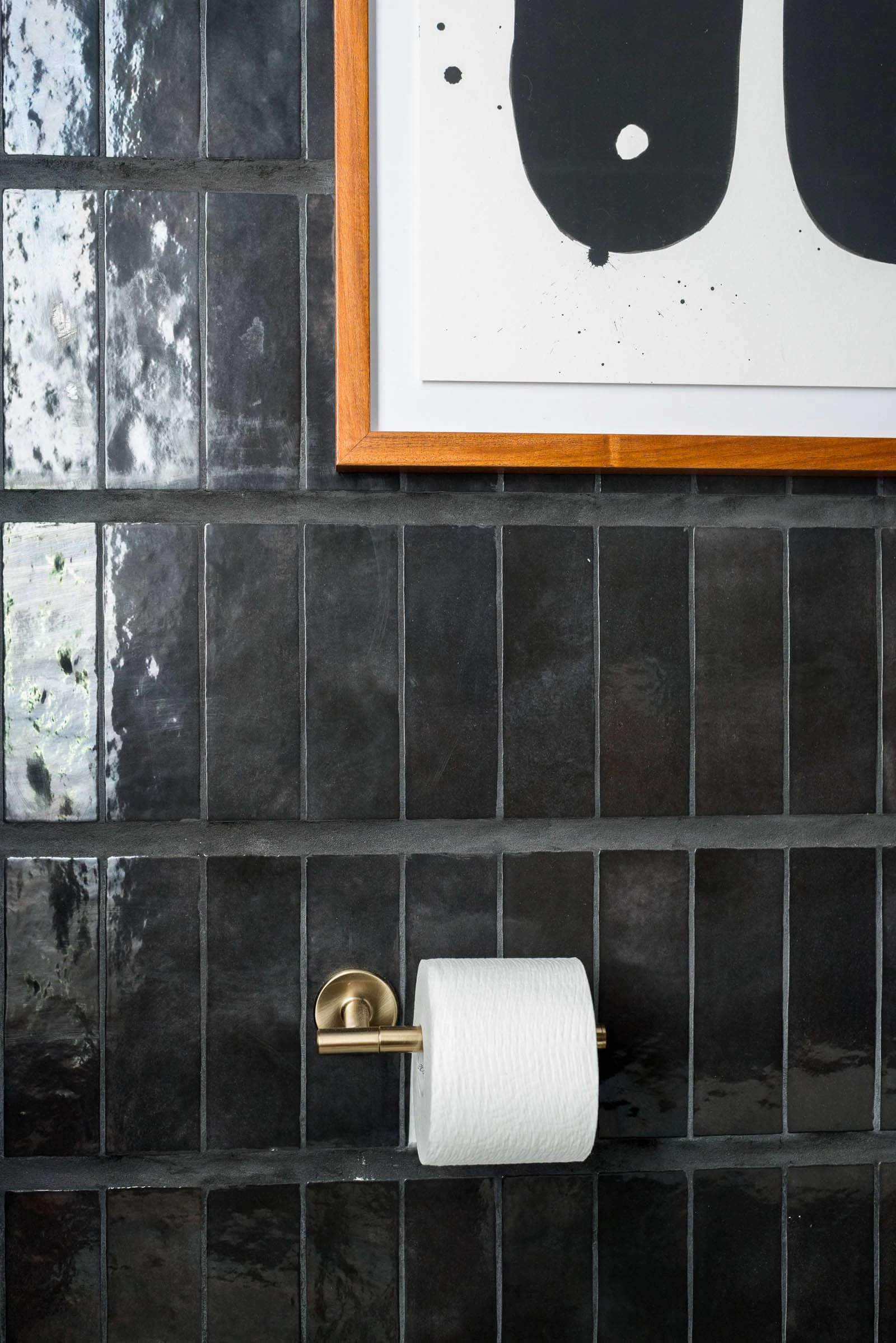 Black wall tile in powder bathroom. 