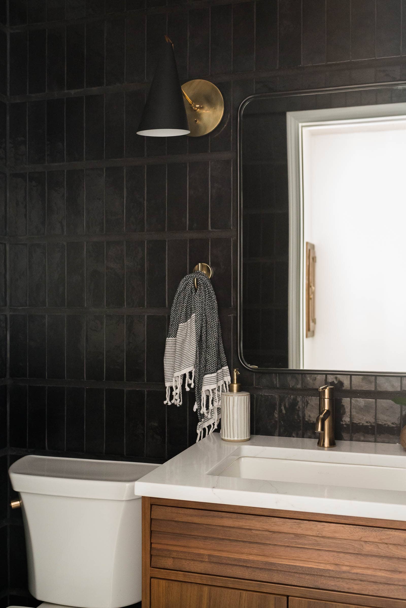 Modern Powder Room: Black wall tile in powder bathroom 