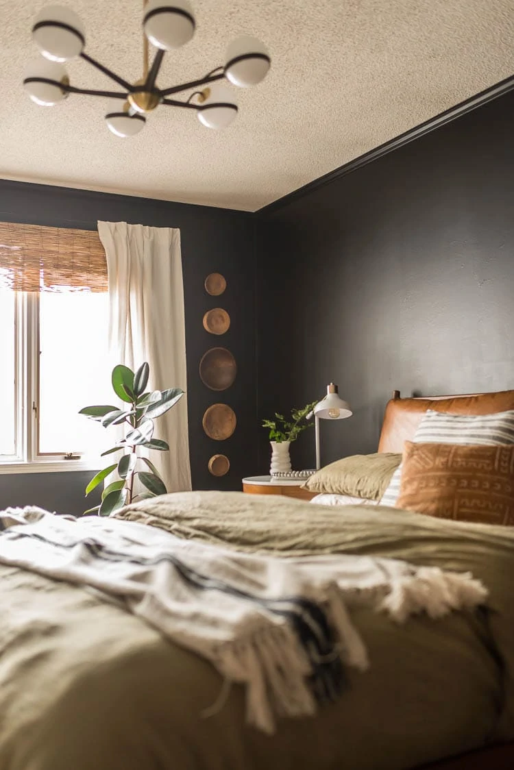 Dark bedroom with wood bowls on wall