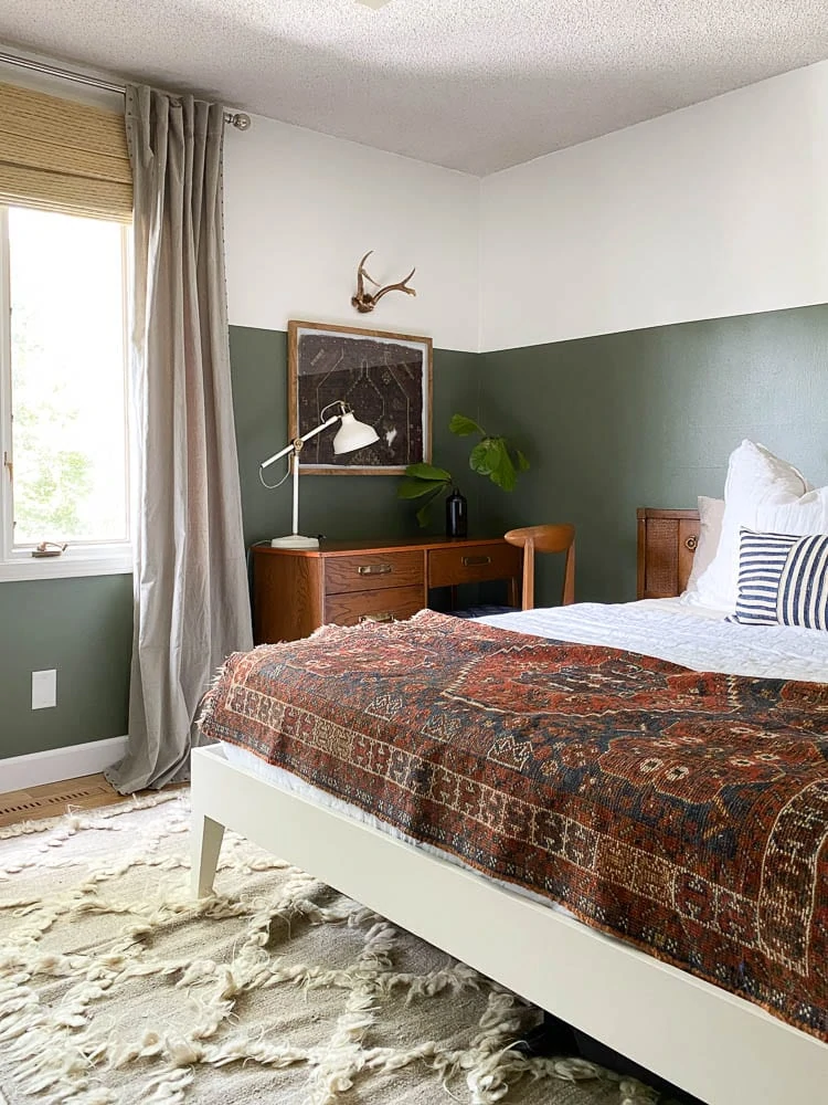 Mid-Century Modern Bedroom with vintage rugs, green walls and lots of textiles. 