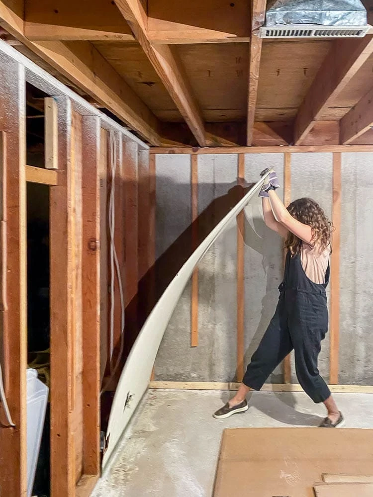 Woman taking down wall paneling