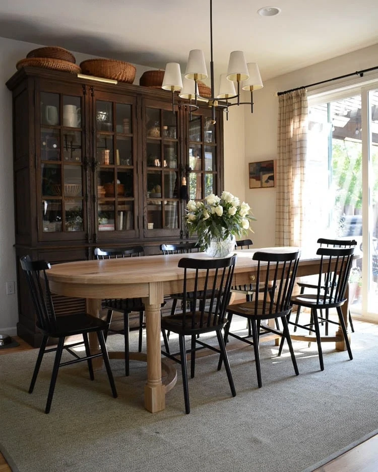 Modern Traditional dining room with oak table and black chairs. 