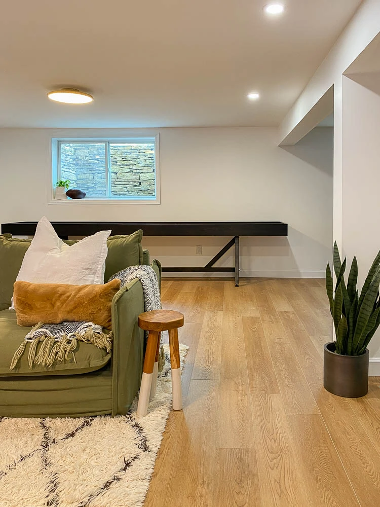 sharing a custom shuffleboard in a basement 