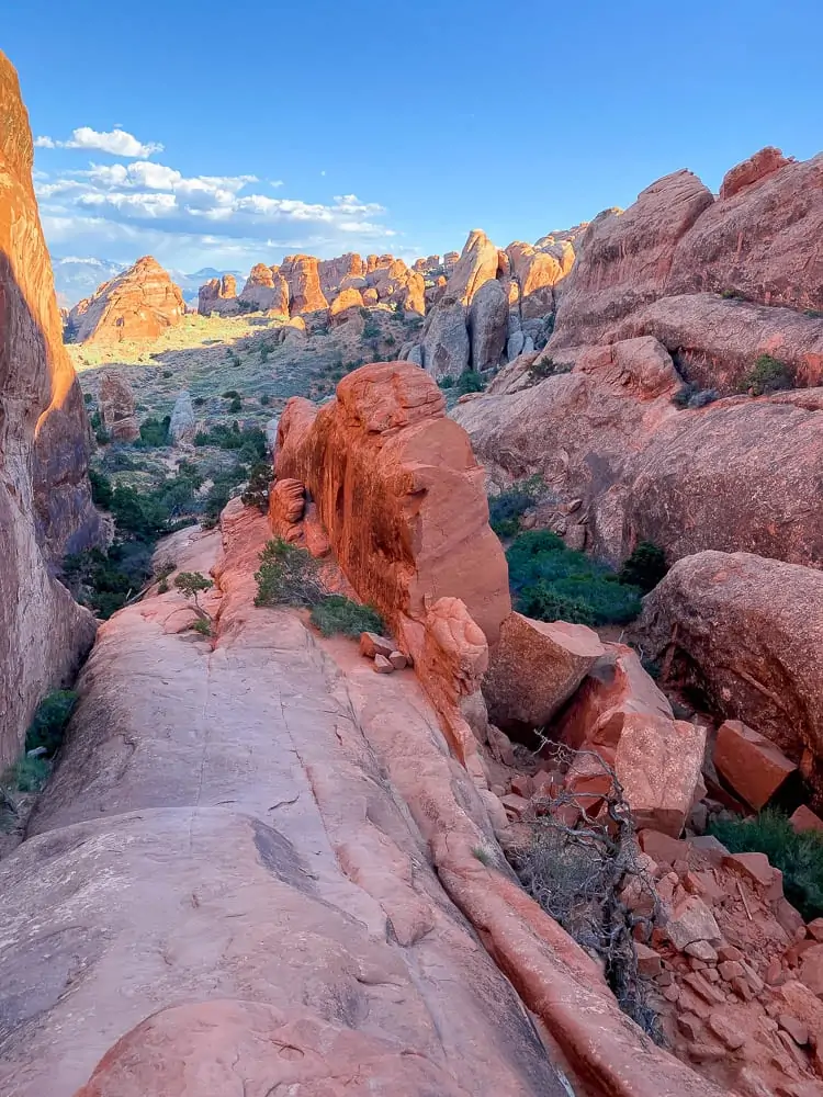 Hiking Double O Arch in Arches National Park showing the fin. 