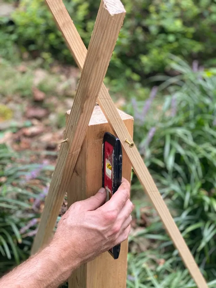 adding supports to little free library post as concrete dries