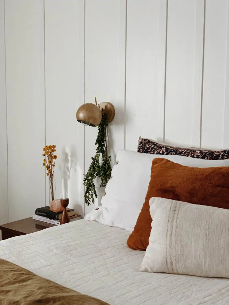 hang greenery from sconce in bedroom for Christmas